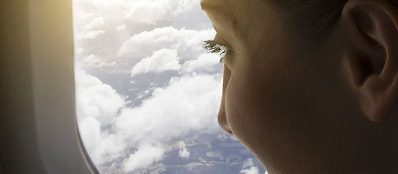 Person looking out of Airplane window Person looking out of Airplane window