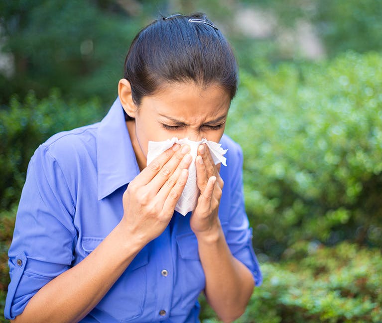 Woman is warming her nose and sinuses.