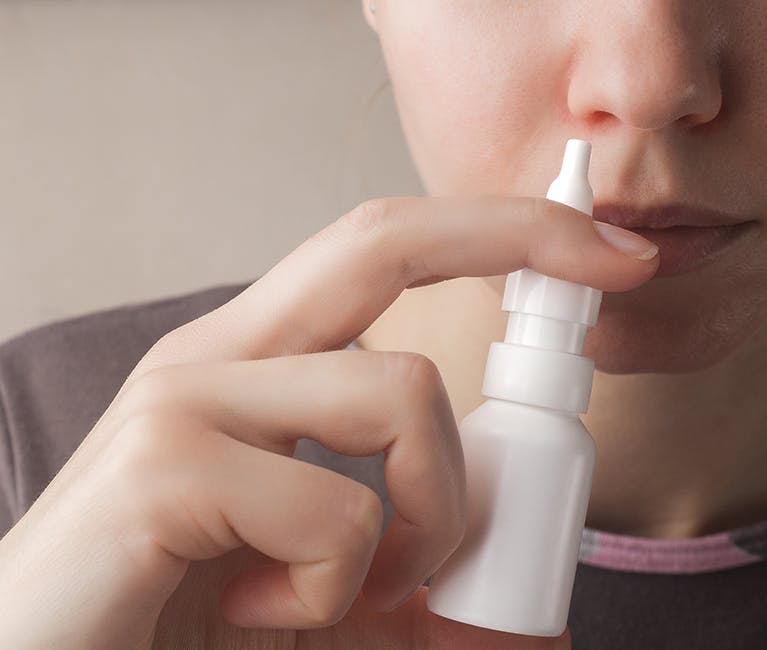 627170372 Man suffering nasal congestion massages his sinuses