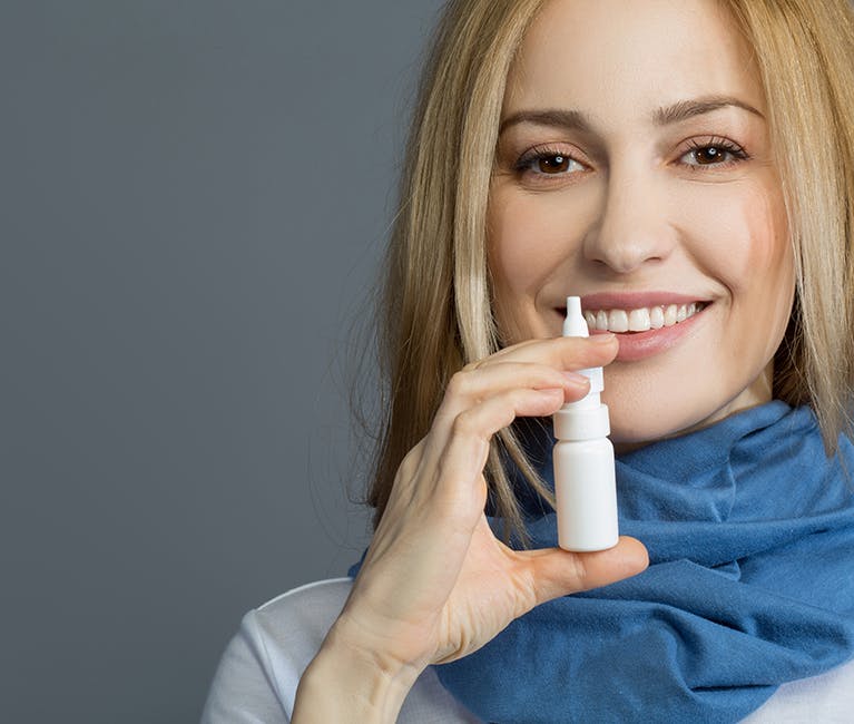1028895514 Man suffering nasal congestion massages his sinuses