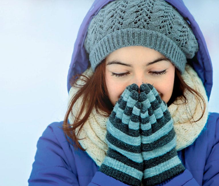Woman is warming her nose and sinuses.