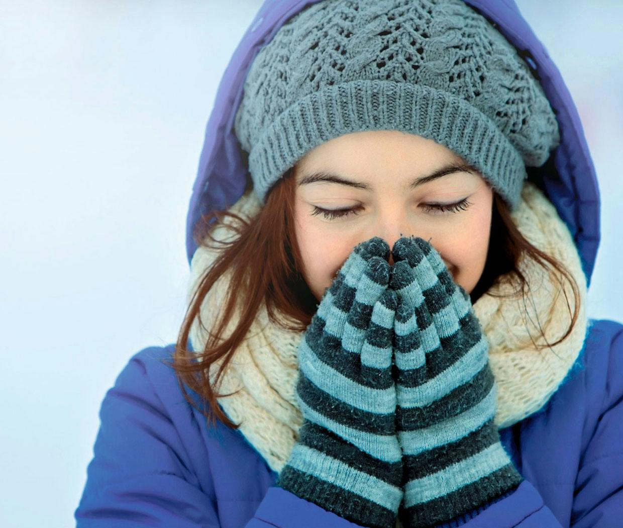 Woman is warming her nose and sinuses.