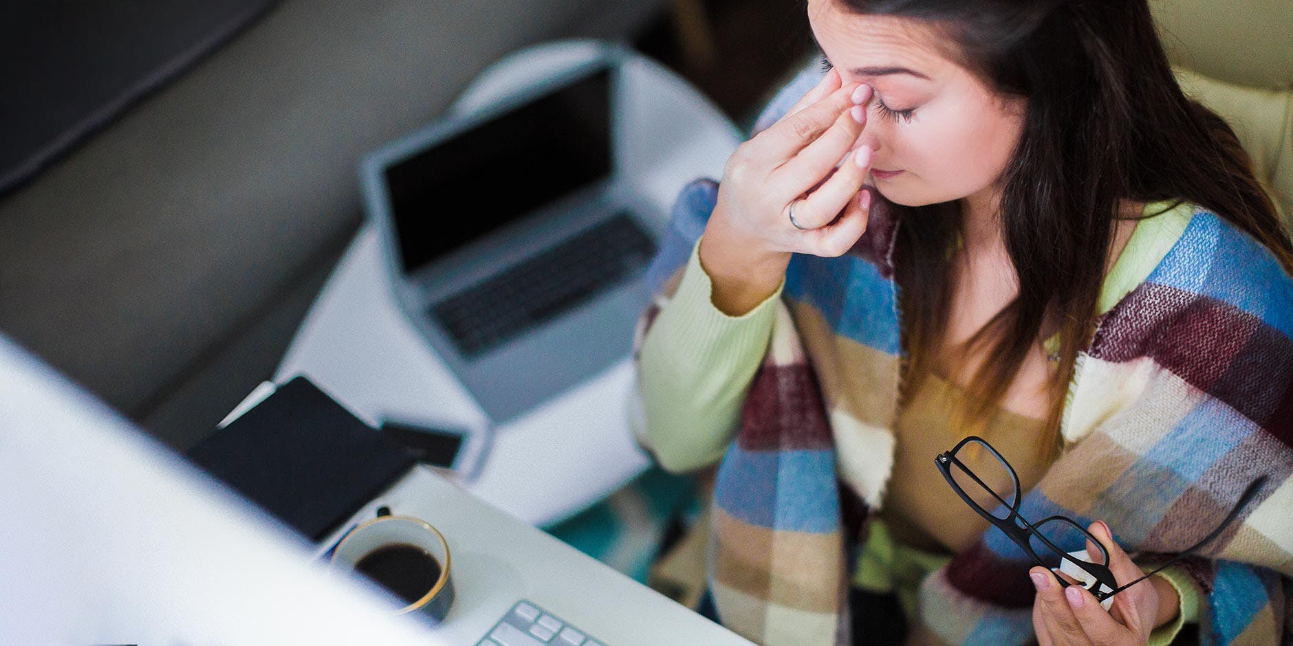 A man is wearing a warm At and coat whilst breathing in the cool winter air.