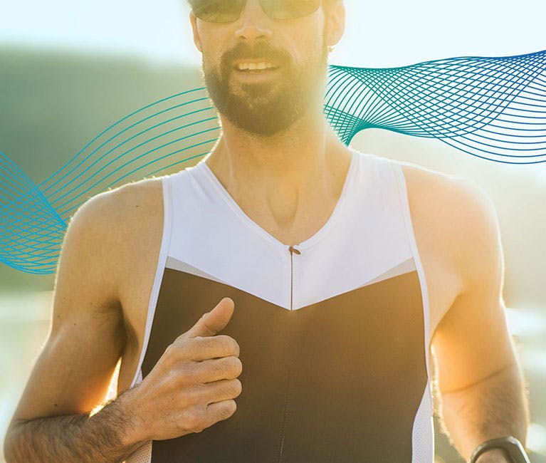 Man running with the sun shining behind him