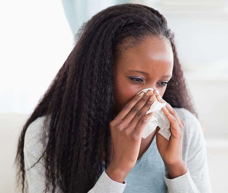 Woman is warming her nose and sinuses.