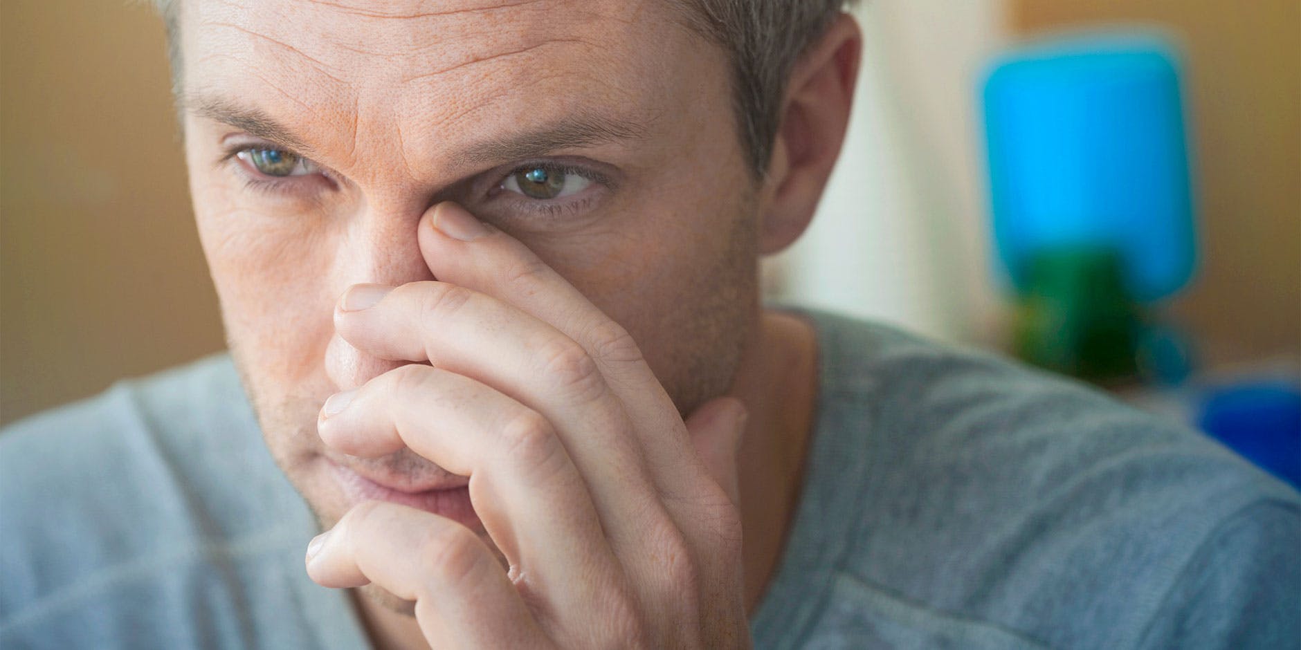 Homme souffrant de congestion nasale en train de se masser les sinus