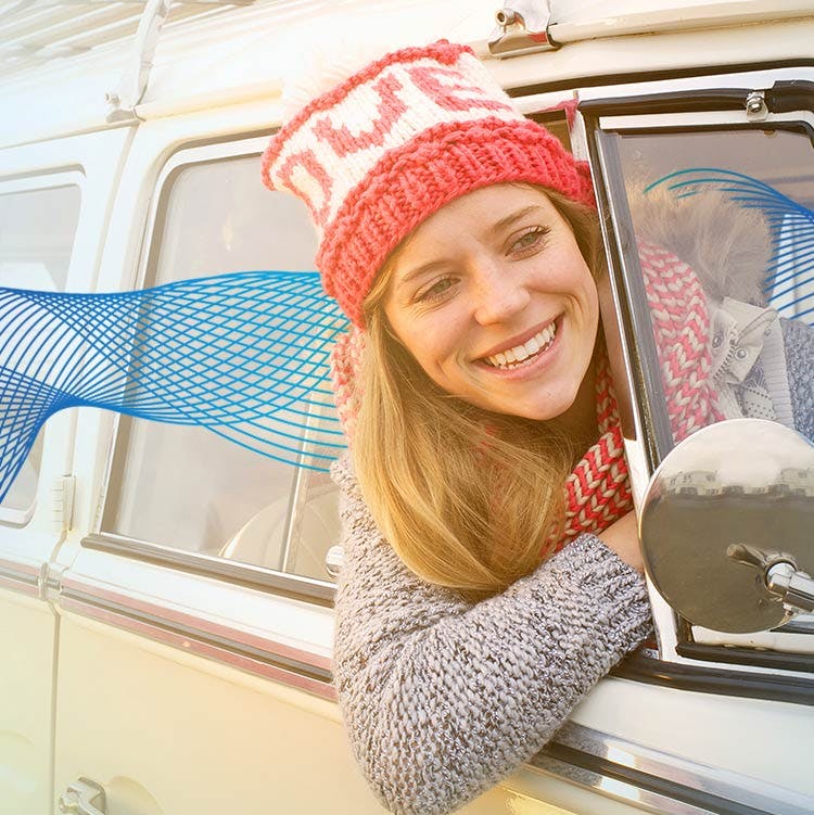 Woman smiling with head outside car window