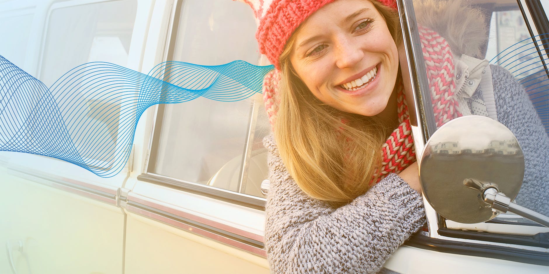 Woman smiling with head outside car window otrivine