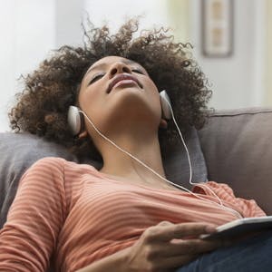 Woman resting while listening to music