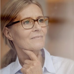 Woman with glasses thinking