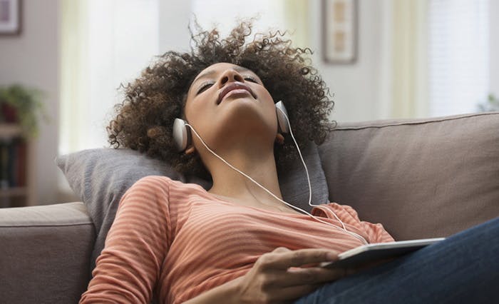 Woman resting while listening to music
