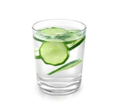 Glass of water with cucumbers in it