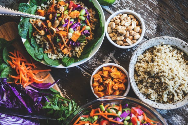 A table with bowls of vegetables and whole grains