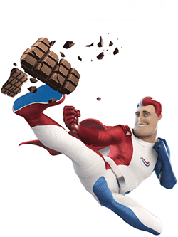 Der Superheld  von Odol-med3 wie er in der Luft einer Tafel Schokolade einen Tritt verpasst und diese in viele Stücke zerbricht.
