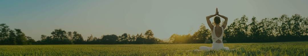 Woman in a sitting yoga pose outside