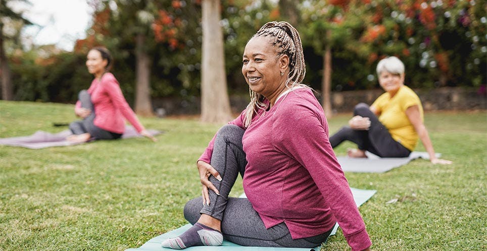 Women doing outdoor yoga in a park