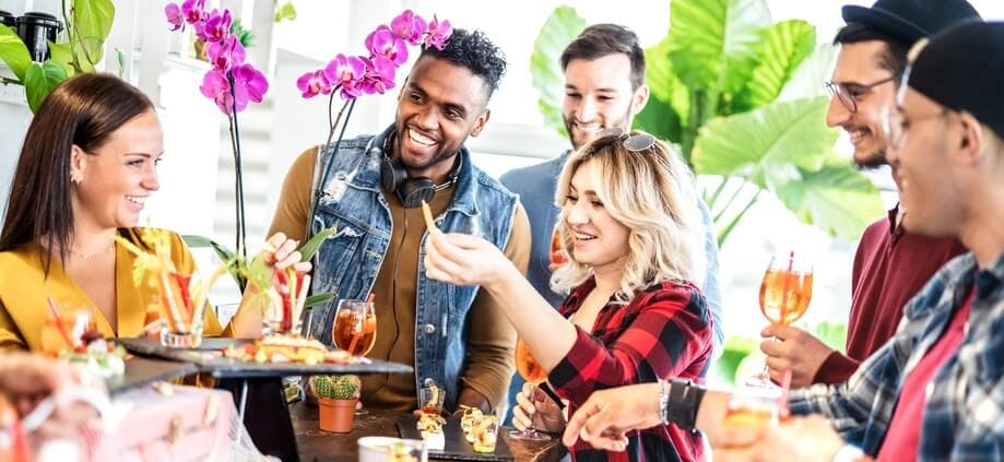 Friends passing around a tray of food at a party