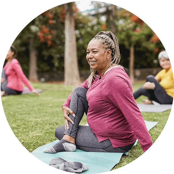 Women doing outdoor yoga in a park