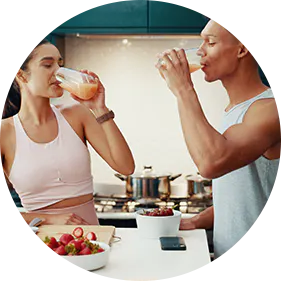 Man and woman drinking juice and eating a gut-friendly breakfast