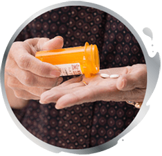 A man pouring pills out of bottle into his hand