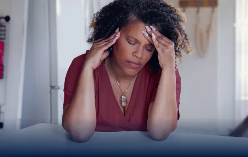 Woman holding her head in pain