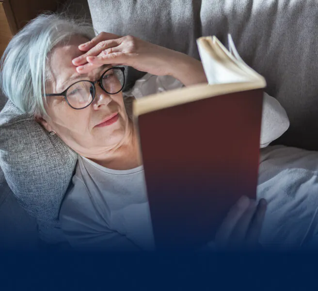 Woman reading a book on a couch