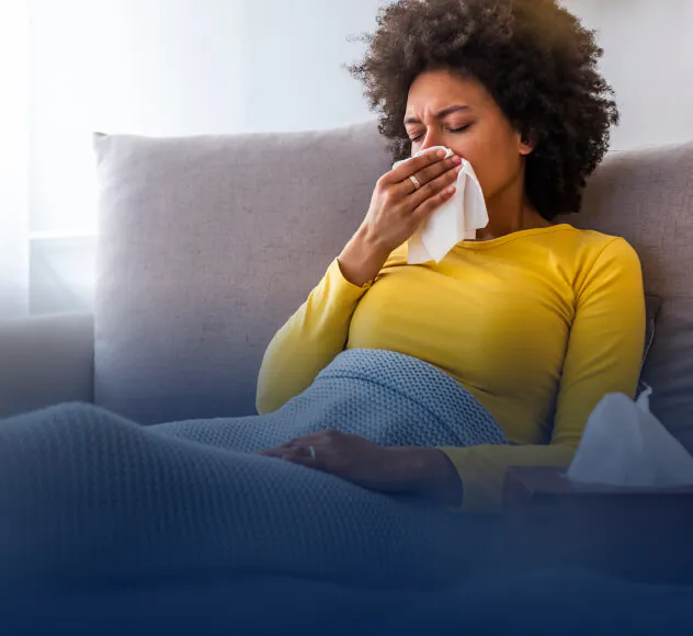 Woman sitting on a couch with tissue