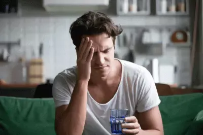 Young man suffering from strong headache.