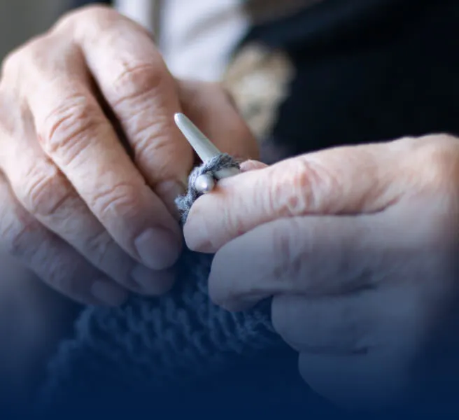 Older woman knitting 