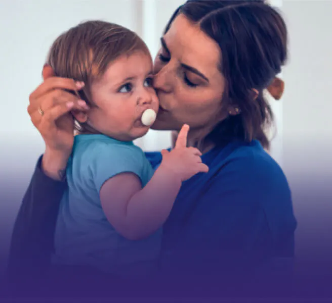 Mother holding and kissing the baby