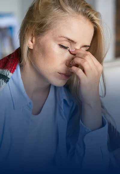 Person holding head in pain
