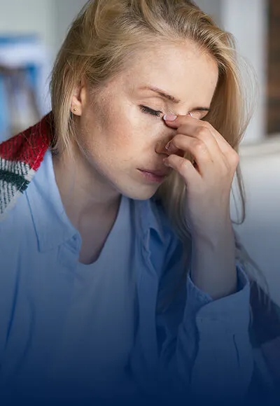 Person holding head in pain