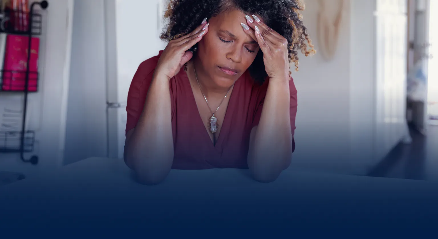 Woman holding her head in pain