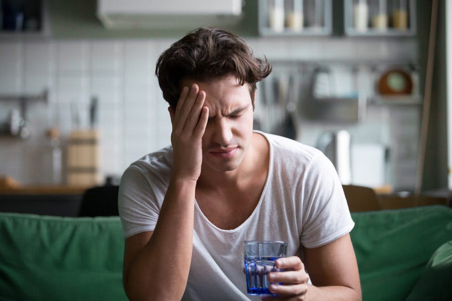 Young man suffering from strong headache.