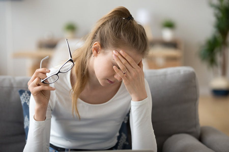 Woman holding her head in pain