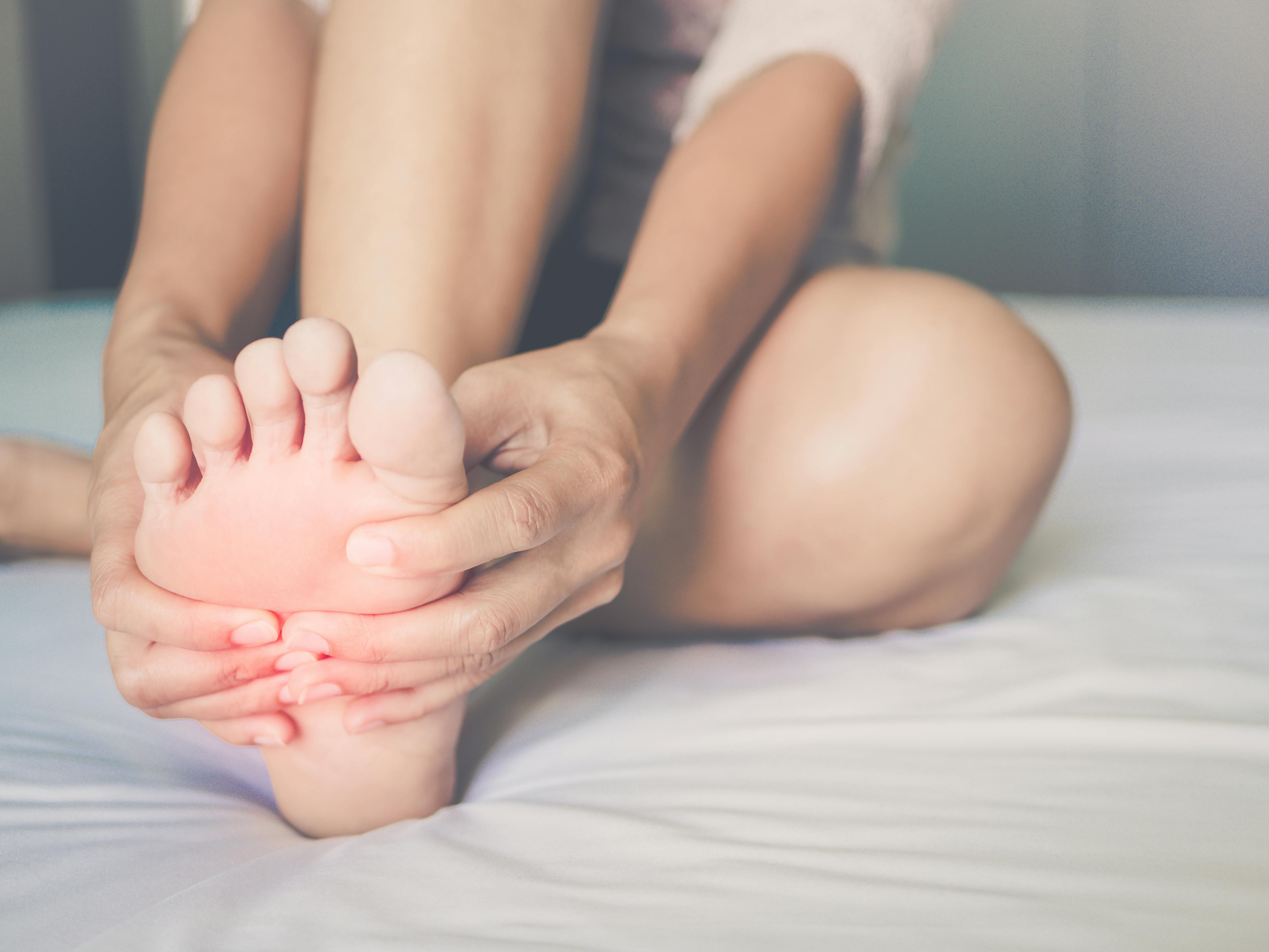 Woman massaging her sore feet