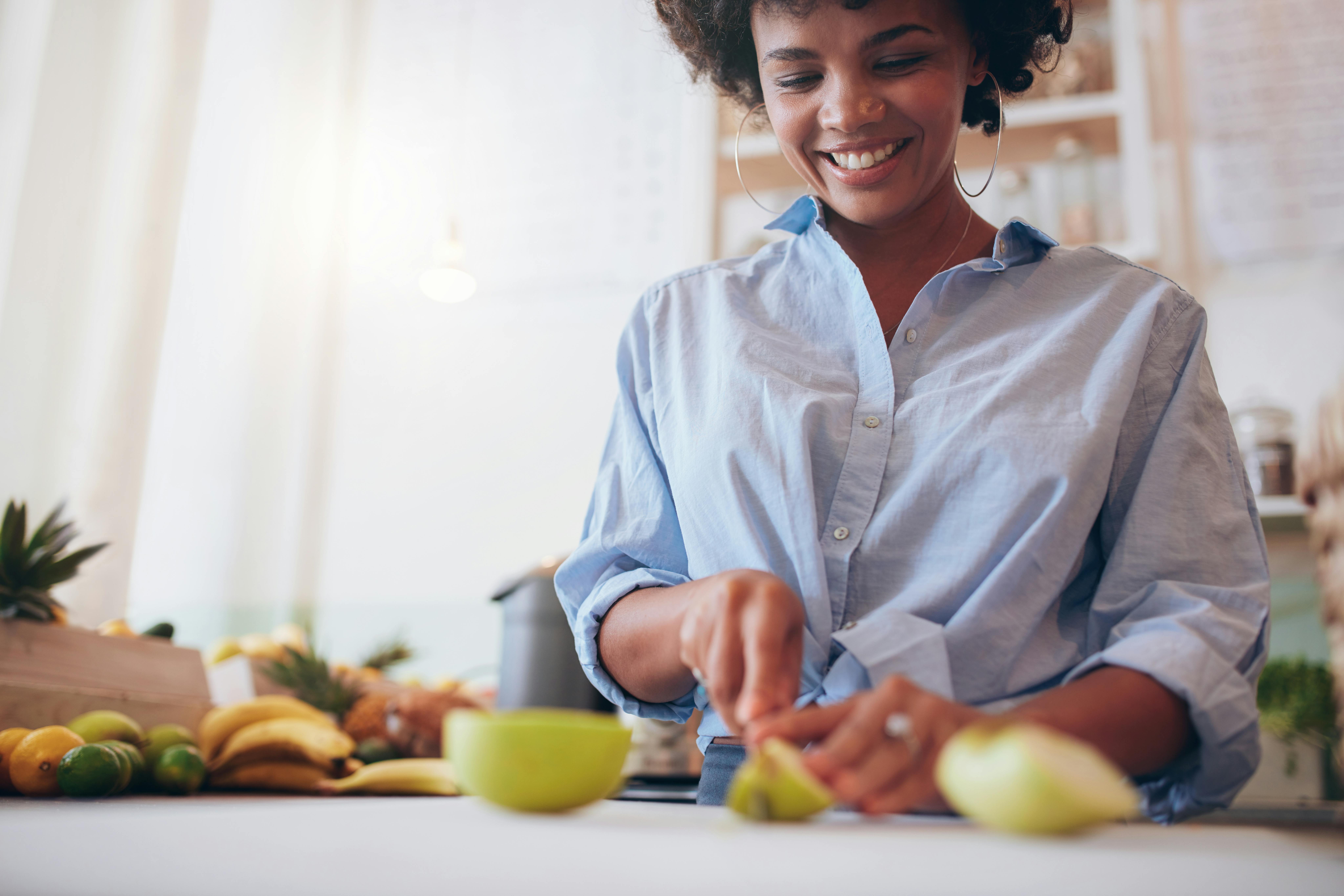 Woman cutting fruit at a juice bar