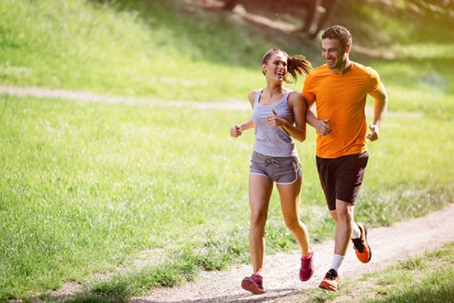 Happy couple running outdoors 