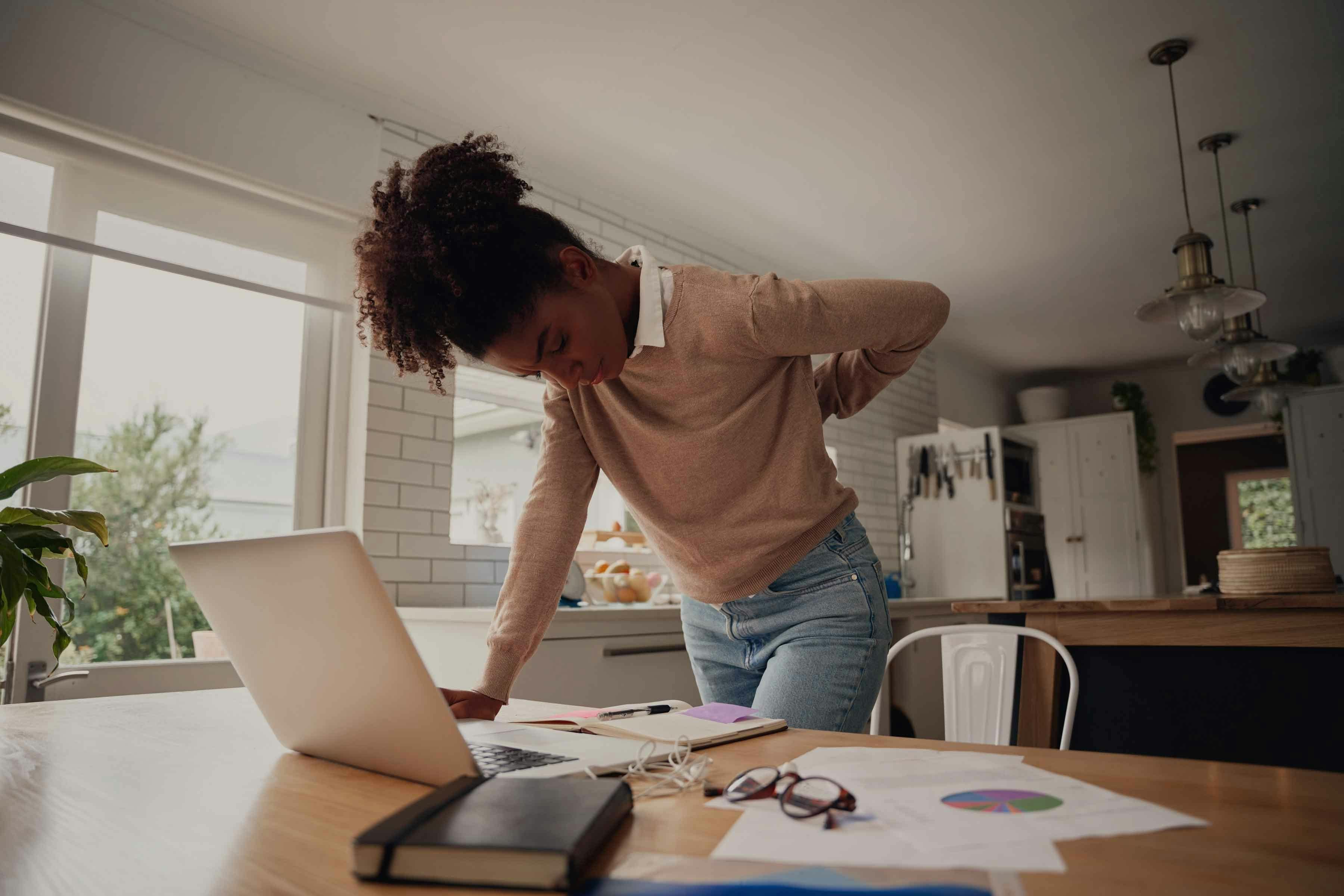 Woman leaning over and clutching back