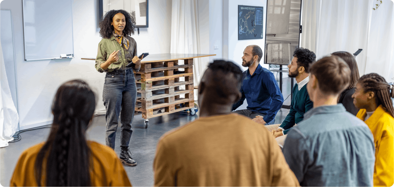 Educator standing in front of a classroom of participants