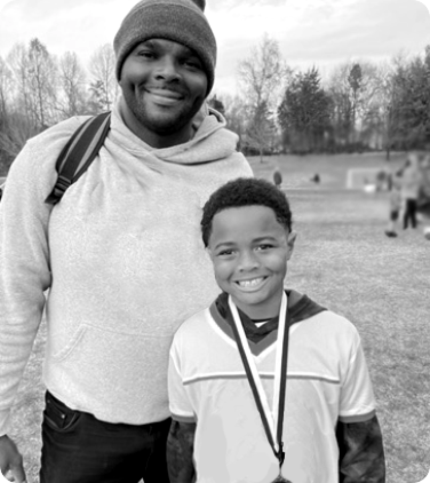 Candid photo of Mark and child wearing medal