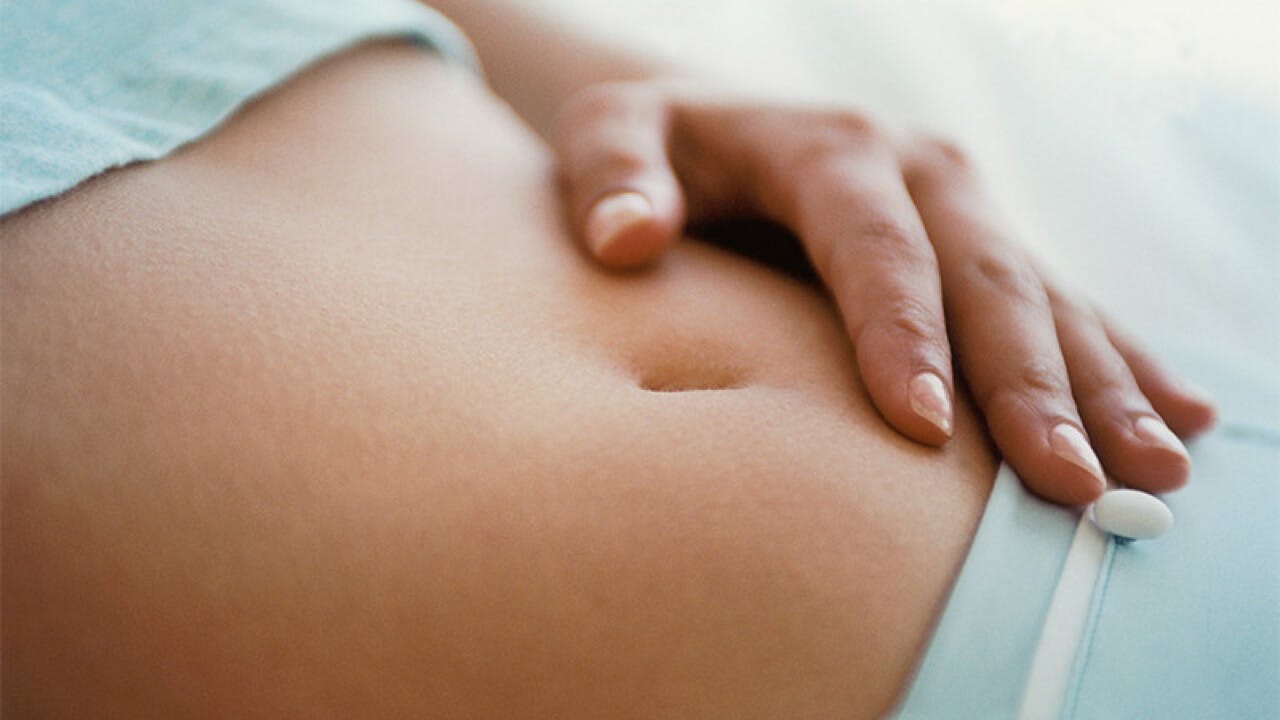 woman touching her belly