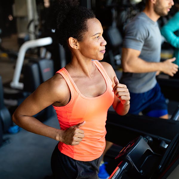 Woman running on a treadmill in an exercise class 