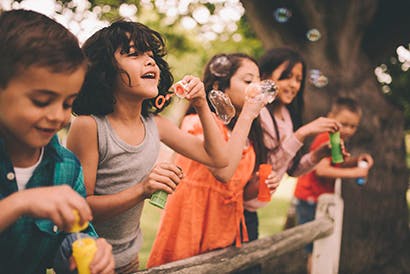 Children blowing bubbles