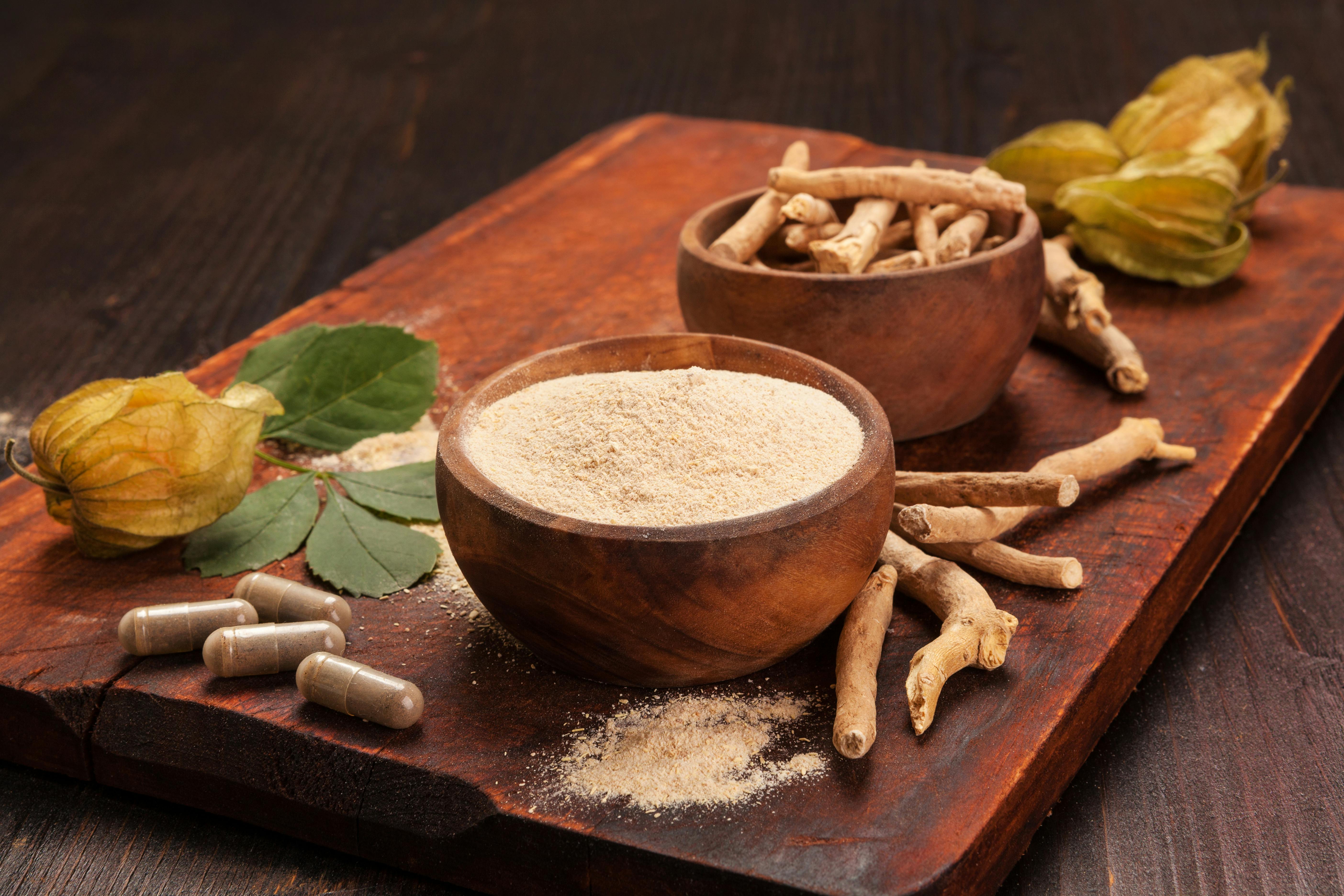 roots and powder of ashwagandha on a wooden board