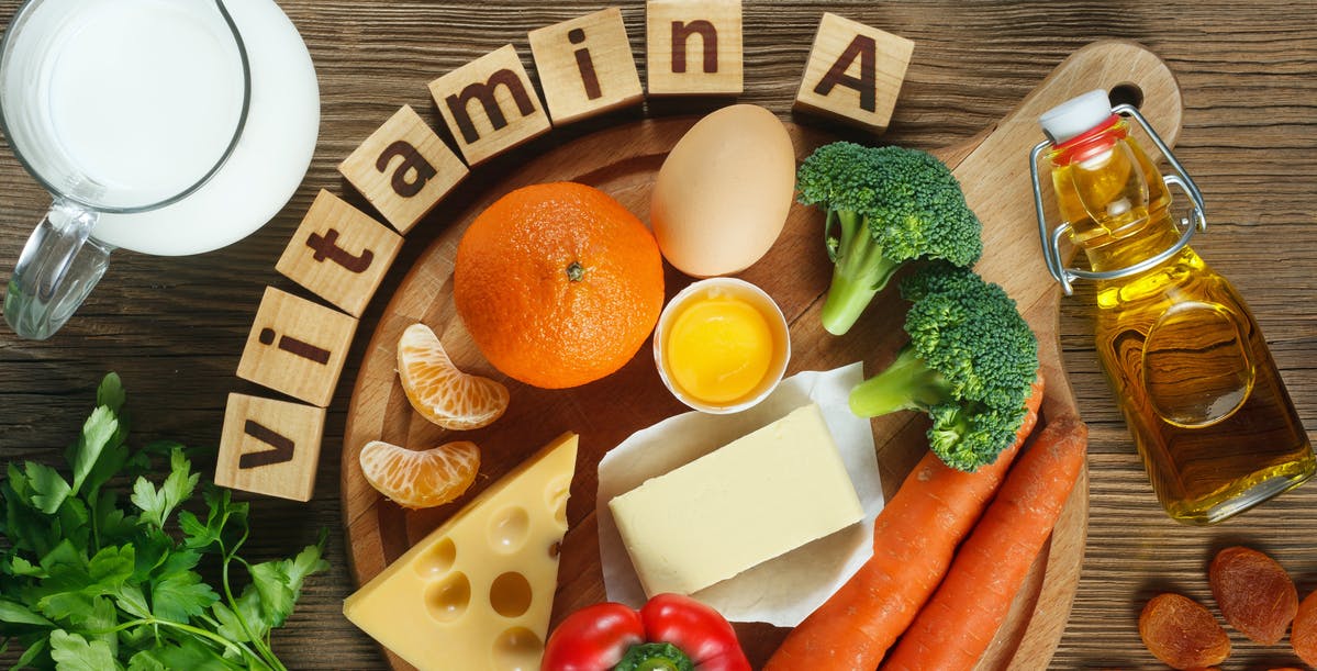 The word vitamin A spelled in block letters, surrounded by foods that contain vitamin A