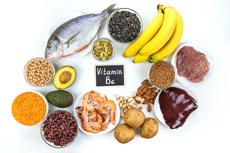 Foods containing vitamin B6, including fish, bananas, meat, potatoes, nuts, beans, and chickpeas.