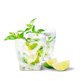Mint Lime Refresher drink in high ball glass with lime wedges