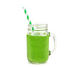 Green Dream Smoothie with striped green and white straw in clear glass.