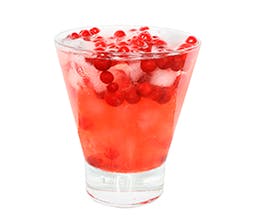 The Pominator festive red drink in glass with cranberries and ice cubes